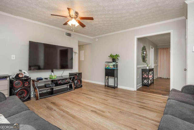 living room featuring hardwood / wood-style floors, crown molding, a textured ceiling, and ceiling fan