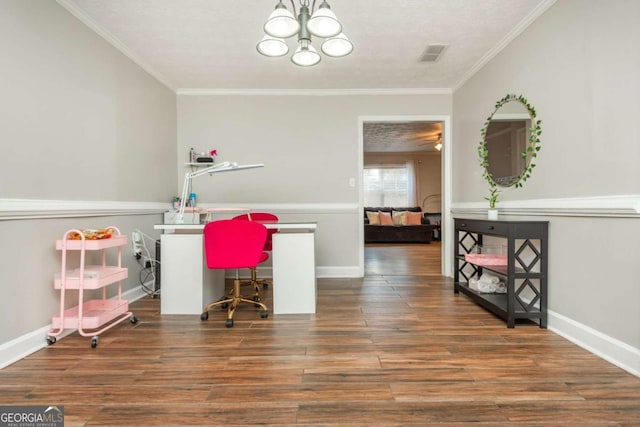 home office with dark wood-type flooring, ornamental molding, and an inviting chandelier