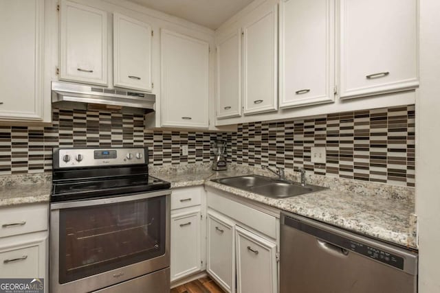 kitchen featuring stainless steel appliances, white cabinetry, sink, and tasteful backsplash