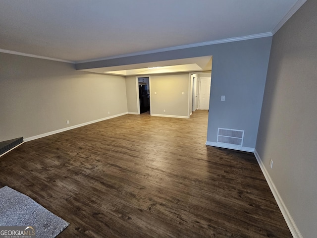 spare room with visible vents, crown molding, baseboards, and wood finished floors