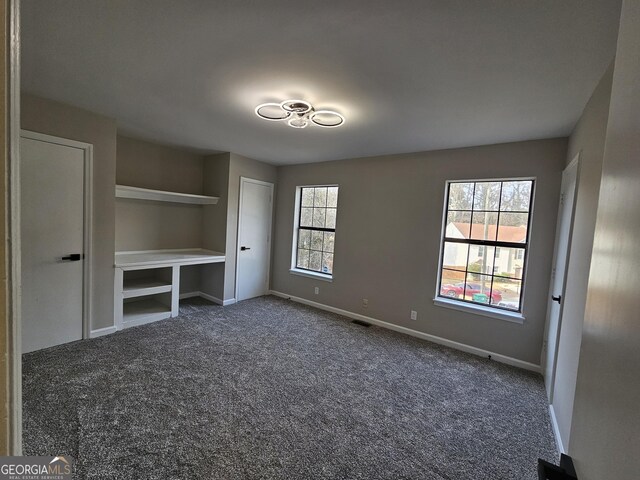 laundry room with electric dryer hookup, hookup for a washing machine, and dark colored carpet