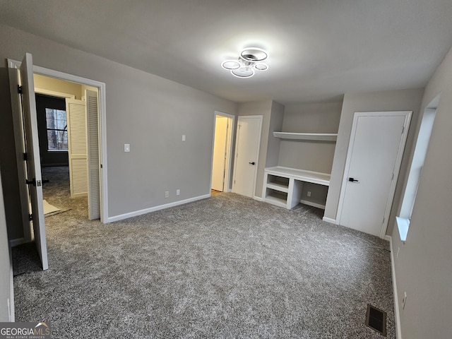 unfurnished bedroom featuring dark colored carpet