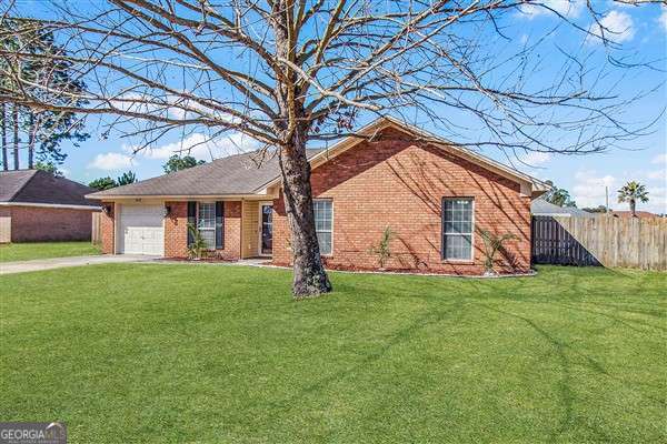 single story home with a garage and a front yard