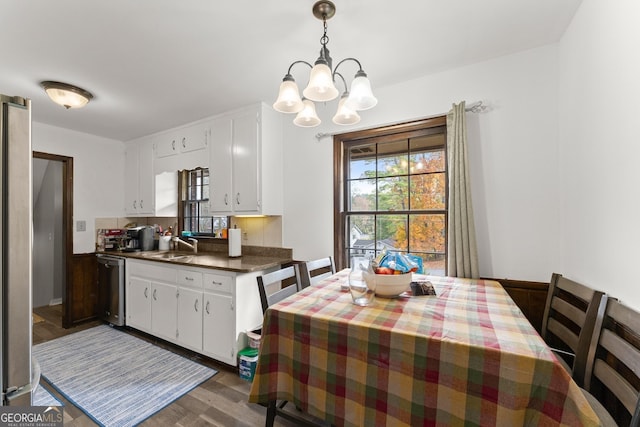 interior space with dark wood-type flooring, sink, and an inviting chandelier