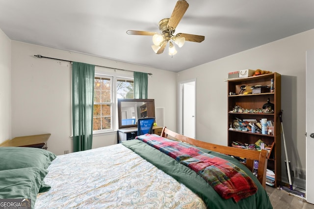 bedroom with wood-type flooring and ceiling fan