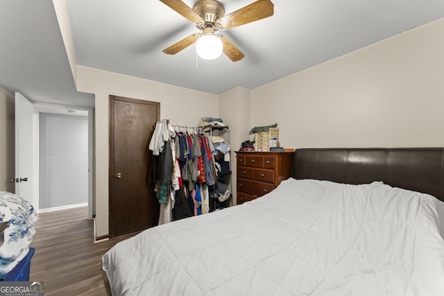 bedroom with ceiling fan and dark hardwood / wood-style floors