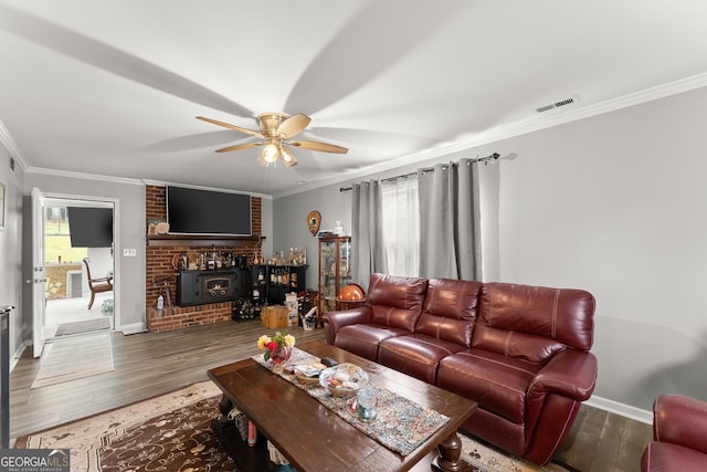 living room with hardwood / wood-style flooring, ornamental molding, and ceiling fan