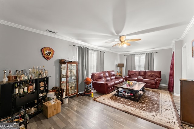 living room featuring hardwood / wood-style flooring, ceiling fan, and ornamental molding