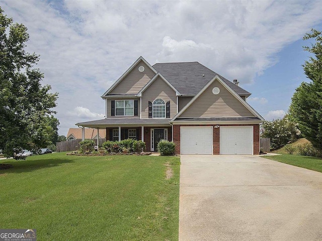 view of front facade featuring a garage, a front yard, and a porch