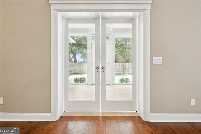 entryway featuring hardwood / wood-style floors and french doors