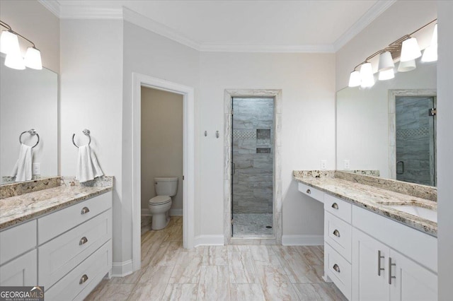 bathroom with crown molding, vanity, toilet, and a shower with door