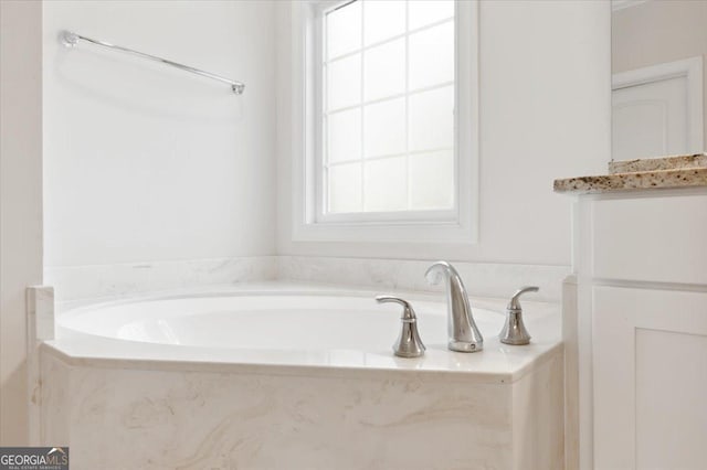 bathroom featuring vanity and a bathtub