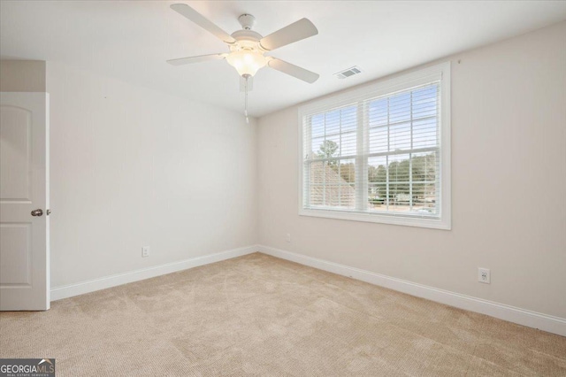 carpeted empty room featuring ceiling fan