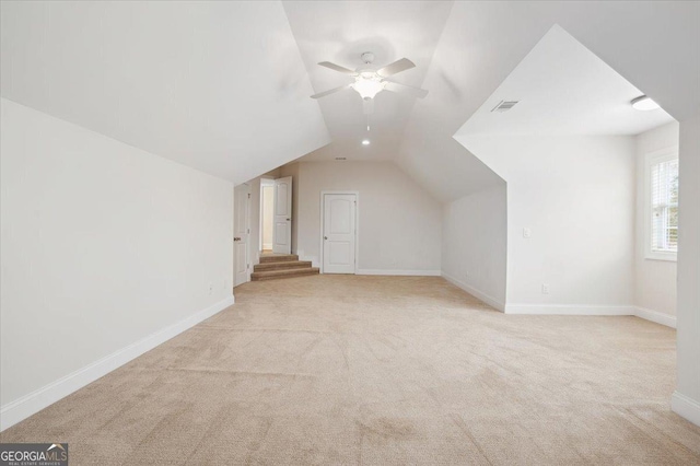 bonus room with ceiling fan, light colored carpet, and vaulted ceiling