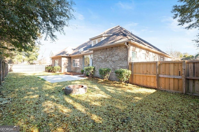 view of yard with a patio area and a fire pit