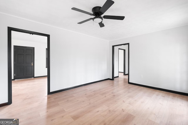 unfurnished room with ornamental molding, ceiling fan, and light wood-type flooring