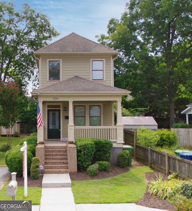 view of front of property with a porch and a front yard