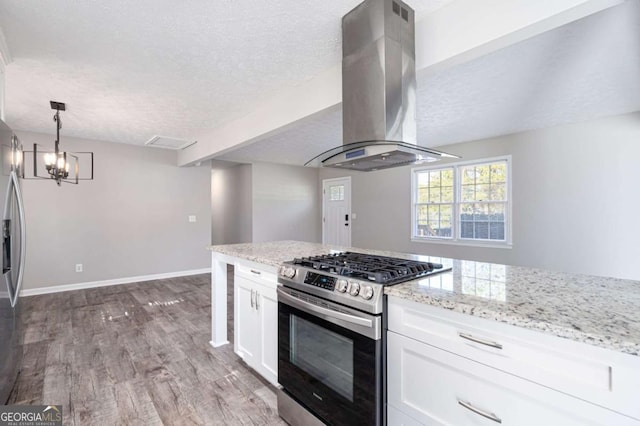 kitchen with white cabinetry, light stone counters, wood-type flooring, appliances with stainless steel finishes, and island exhaust hood