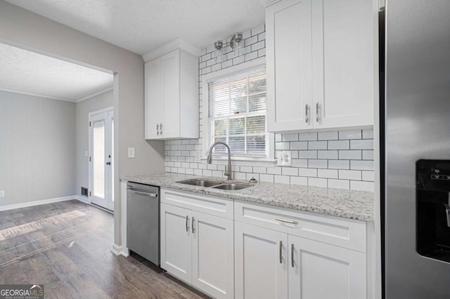 kitchen featuring stainless steel appliances, sink, and white cabinets