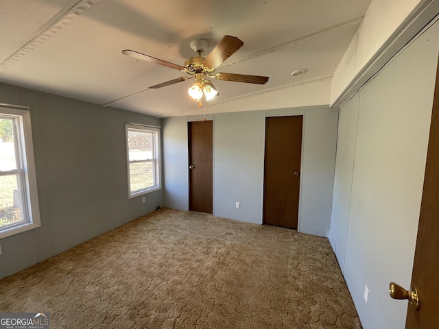 unfurnished bedroom with ceiling fan and carpet floors