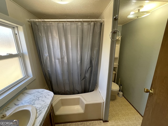 bathroom with vanity, toilet, and a textured ceiling