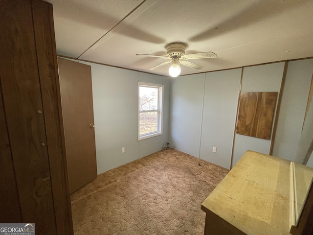 unfurnished bedroom featuring carpet floors and ceiling fan