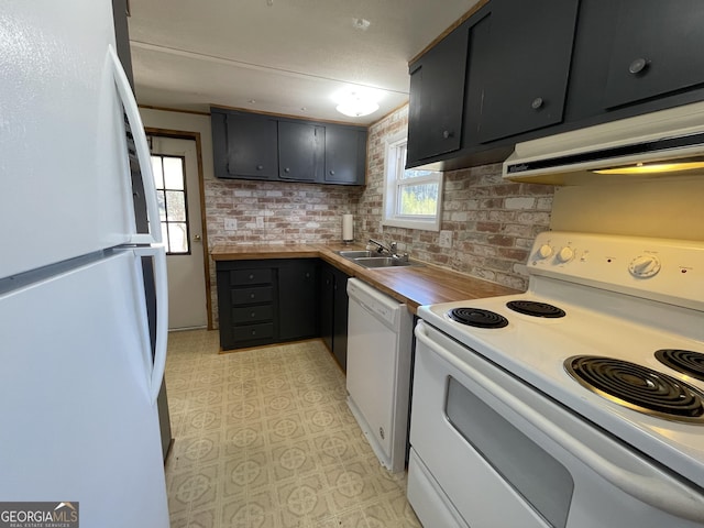 kitchen featuring sink, butcher block countertops, white appliances, brick wall, and exhaust hood