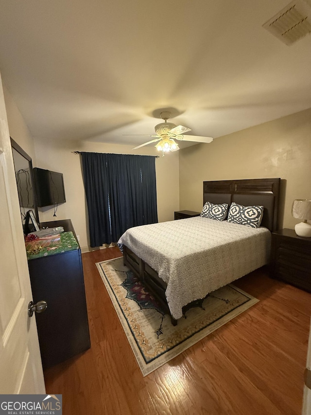 bedroom featuring dark hardwood / wood-style flooring and ceiling fan