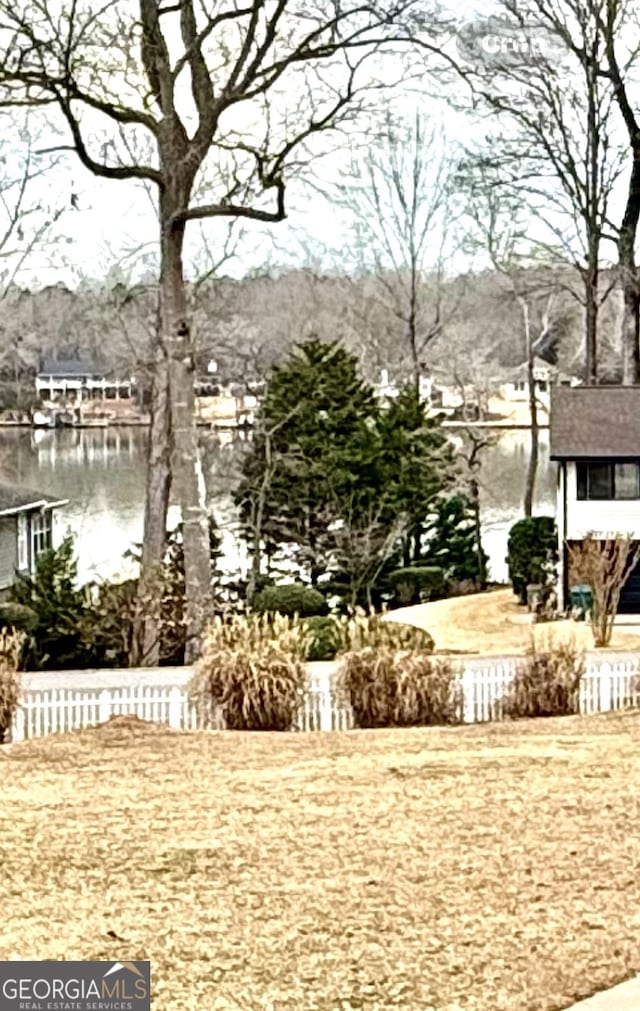 view of yard with fence and a water view