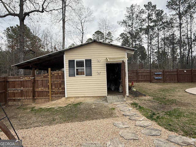 back of house with an outdoor structure