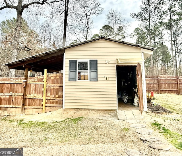 view of outbuilding with an outdoor structure and fence