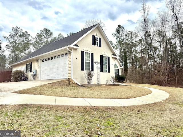 view of home's exterior with concrete driveway, a garage, and stucco siding