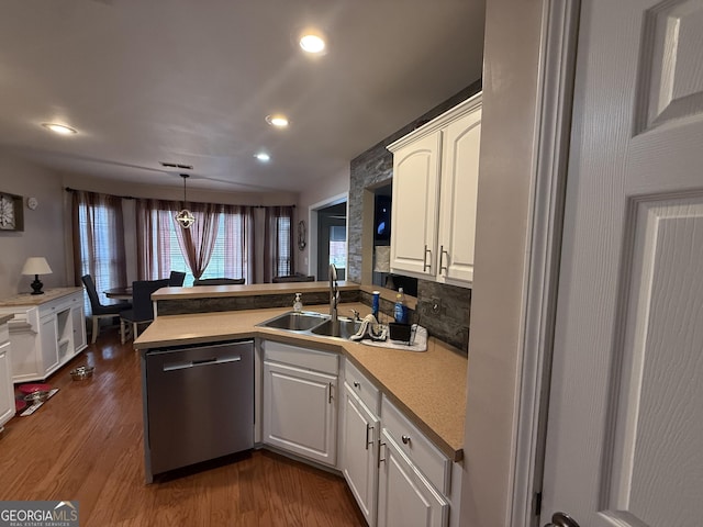 kitchen with sink, white cabinetry, decorative light fixtures, stainless steel dishwasher, and kitchen peninsula