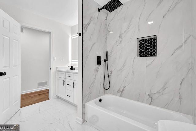 bathroom with vanity and tiled shower / bath combo