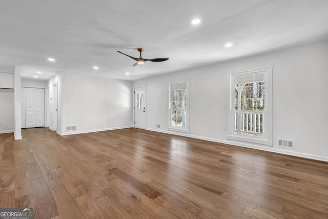 spare room with hardwood / wood-style flooring and ceiling fan