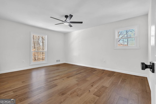 empty room featuring hardwood / wood-style flooring and ceiling fan