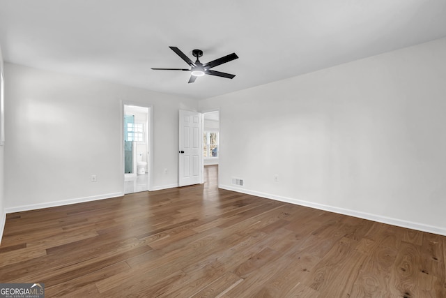 spare room with ceiling fan and wood-type flooring