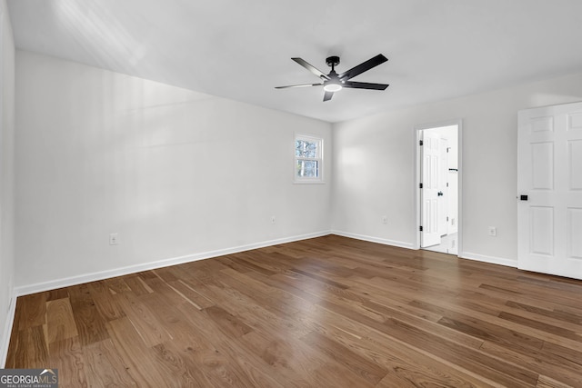 empty room featuring wood-type flooring and ceiling fan