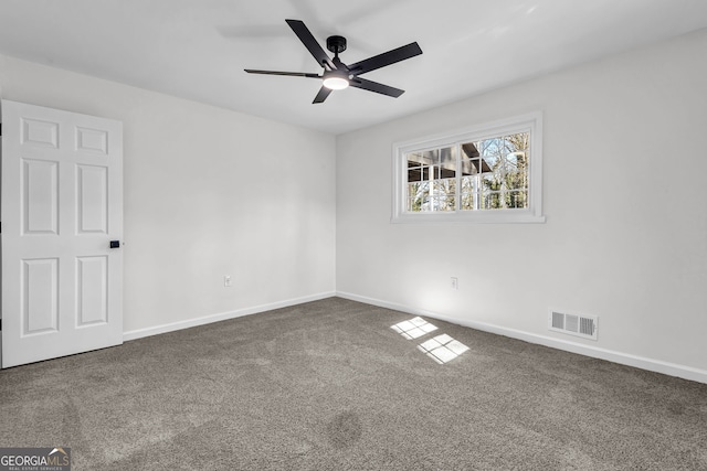 carpeted spare room featuring ceiling fan