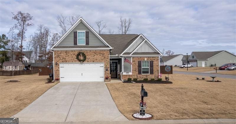 craftsman-style home with a garage and a front yard