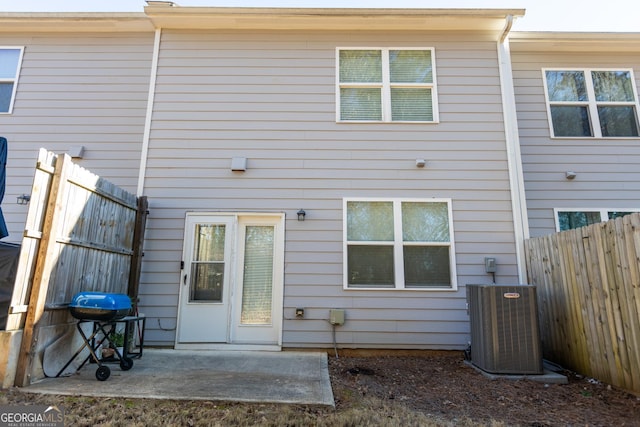 rear view of property with central AC unit and a patio area