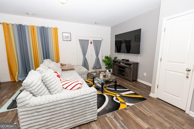 living room with dark hardwood / wood-style flooring