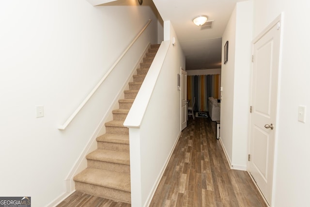 stairs with hardwood / wood-style flooring