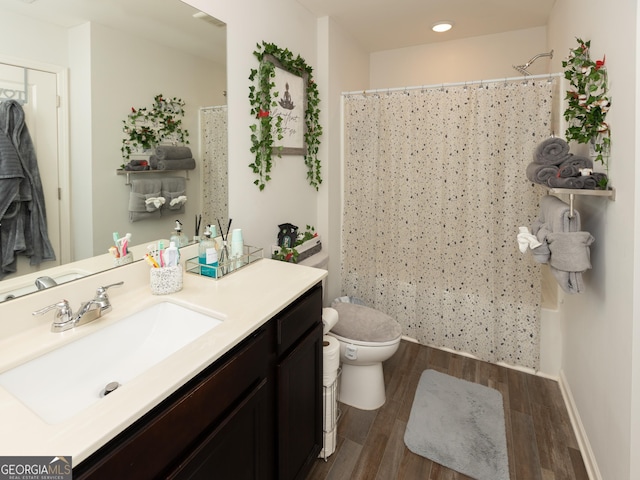 full bathroom with shower / bathtub combination with curtain, wood-type flooring, toilet, and vanity