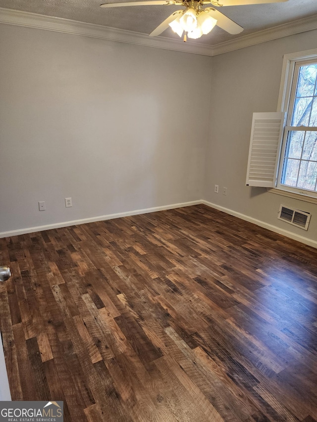 spare room with dark wood-type flooring, ceiling fan, ornamental molding, and a textured ceiling