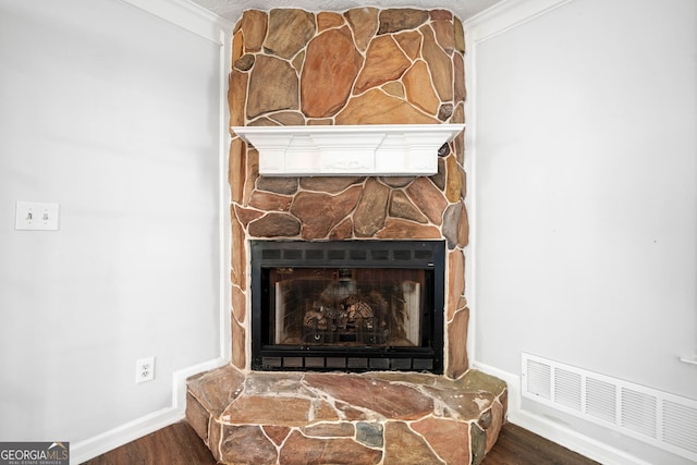 196 Beaver Lake Dr, Ellijay, GA 30540 - details with crown molding, visible vents, a stone fireplace, and wood finished floors