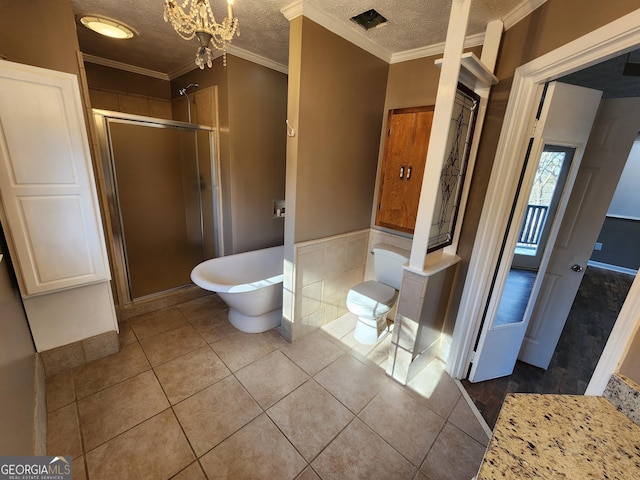 bathroom featuring crown molding, tile patterned floors, shower with separate bathtub, and a textured ceiling