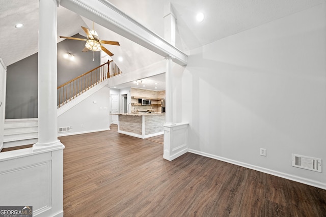 196 Beaver Lake Dr, Ellijay, GA 30540 - unfurnished living room with wood finished floors, high vaulted ceiling, visible vents, and stairs