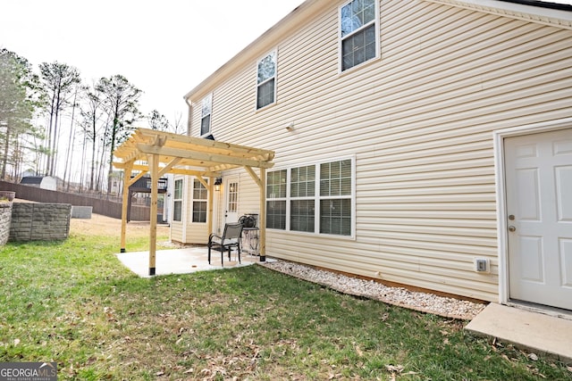 rear view of house with a yard, a patio area, and a pergola