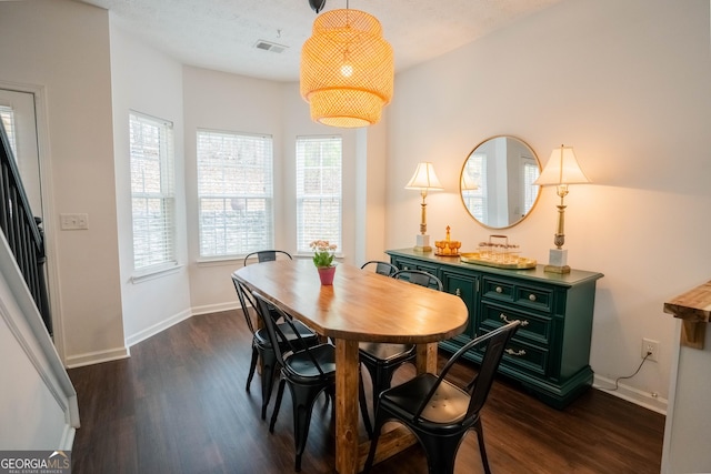 dining area with dark hardwood / wood-style floors